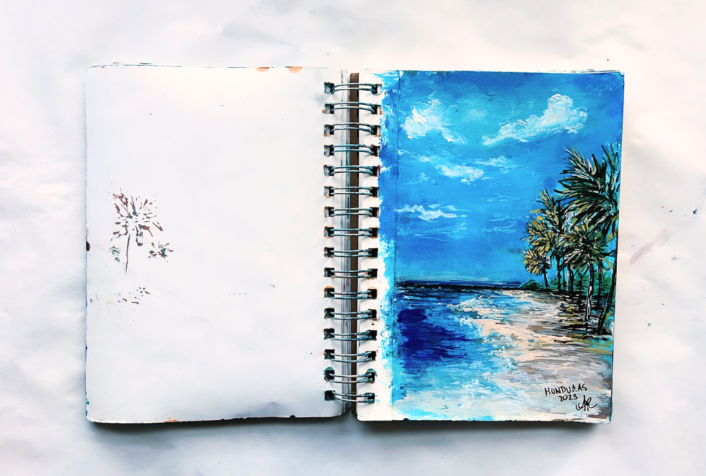 painting on vacation while looking at the honduras crystal blue oceans